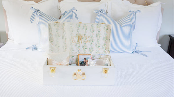 image of white neely and chloe for petite keep keepsake trunk styled on bed and filled with bridal heirlooms