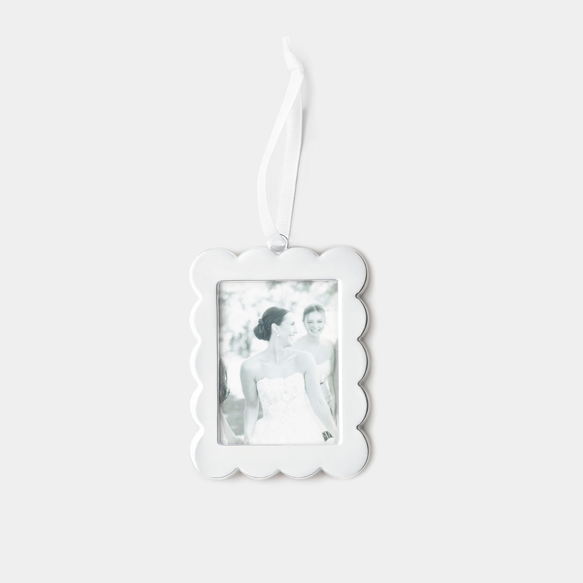 A silver scalloped-edge rectangular photo ornament with a hanging ribbon, shown against a light gray background. The photo insert is a black-and-white image of a bride.