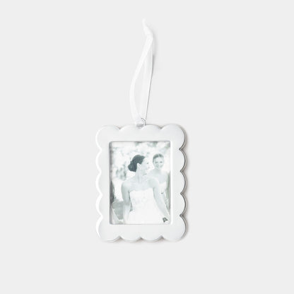 A silver scalloped-edge rectangular photo ornament with a hanging ribbon, shown against a light gray background. The photo insert is a black-and-white image of a bride.